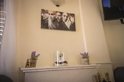 a fireplace with two pictures on the wall at Villa Alexandra in Ayia Napa