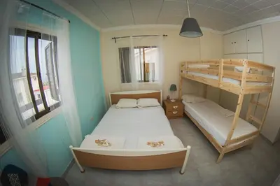 a bedroom with two beds and a bunk bed at Villa Alexandra in Ayia Napa