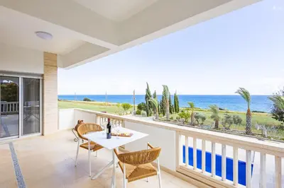 a dining room with a view of the ocean at Villa Chrysta in Ayios Theodhoros
