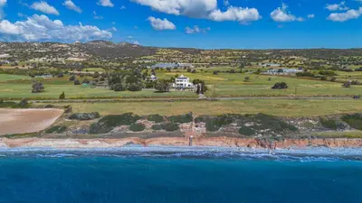 an aerial view of a house on an island in the ocean at Villa Chrysta in Ayios Theodhoros