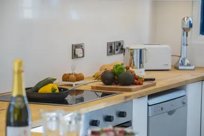 a kitchen counter with fruits and vegetables on a cutting board at Protaras Villa Loulla in Protaras