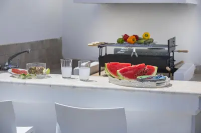 a table with a plate of watermelon on a counter at Protaras Villa Loulla in Protaras