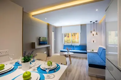 a living room and dining room with a table and chairs at Malama Beach Holiday Village in Protaras