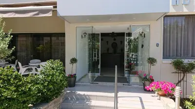 a house with a glass door and a patio at Lordos Hotel Apts Limassol in Limassol