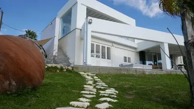 a house with a stone path in front of it at Casa Vacanze Baciata in Ayios Theodhoros