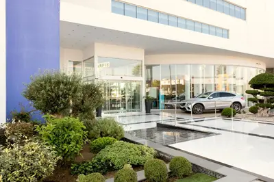 a building with a car parked in front of it at Amethyst Napa Hotel & Spa in Ayia Napa