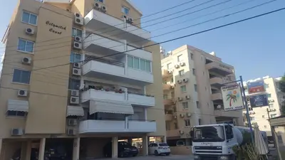 a truck parked in front of a building at Makenzy Apartment in Larnaka