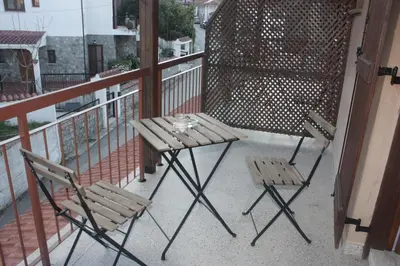 a table and two chairs on a balcony at Maritsa Lodge in Kakopetria