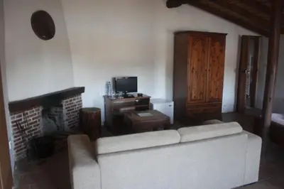 a living room with a white couch and a fireplace at Maritsa Lodge in Kakopetria