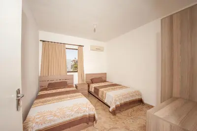 a bedroom with two beds and a window at Ha.De.Co. Holiday Apts in Ayia Napa
