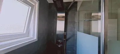 a shower with a glass door next to a window at Ha.De.Co. Holiday Apts in Ayia Napa