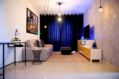 a living room with a couch and a table at Fat Cow Apartment 101 in Larnaka