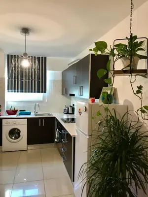 a kitchen with a white refrigerator and a dishwasher at Fat Cow Apartment 101 in Larnaka