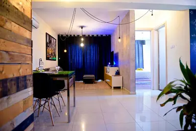 a living room with a table and a dining room at Fat Cow Apartment 101 in Larnaka
