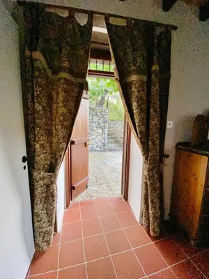 a hallway with a door leading to a kitchen with a door at Arhontiko Askas Mansion in Askas
