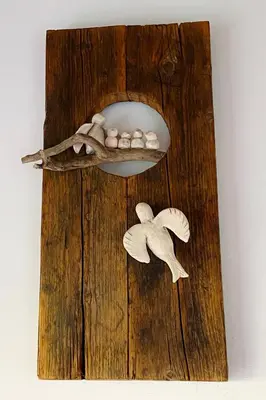 a wooden birdfeeder with a branch and a flower at Arhontiko Askas Mansion in Askas