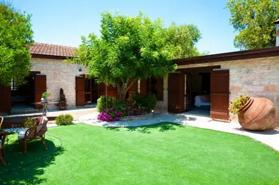 a garden with a lawn and a house at Listed Villa in Laneia in Lania