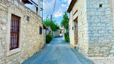 an alley between two stone buildings in a village at Listed Villa in Laneia in Lania