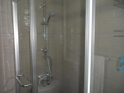 a shower in a bathroom with a glass door at SUNSHINE APTS, TWO BEDROOM , FREE INTERNET, No 3 in Ayia Napa