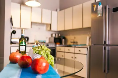 a kitchen with a table with apples and a bottle of wine at Annita Court Block B, Apt6 in Ayia Napa