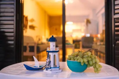 a table with a lighthouse and a bowl of grapes at Annita Court Block B, Apt6 in Ayia Napa