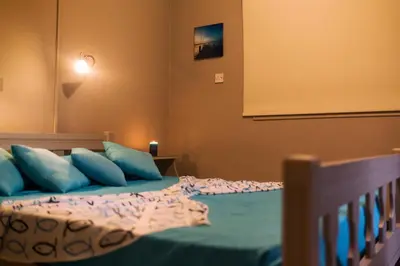 a bedroom with a bed with blue pillows at Annita Court Block B, Apt6 in Ayia Napa