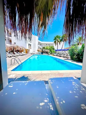 a swimming pool with a view of a resort at Antonis G. Hotel Apartments in Voroklini