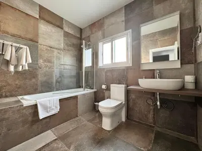 a bathroom with a toilet and a sink and a tub at Vega Apartments in Limassol