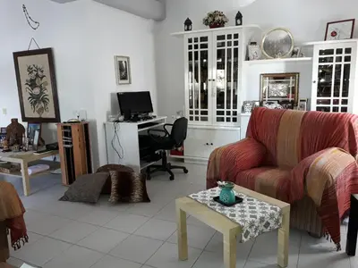 a living room with a couch and a desk at Shared Top 1st floor villa in Limassol