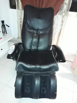 a black leather chair with a phone sitting on it at Shared Top 1st floor villa in Limassol