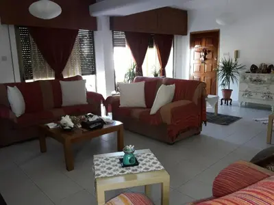 a living room with two couches and a table at Shared Top 1st floor villa in Limassol