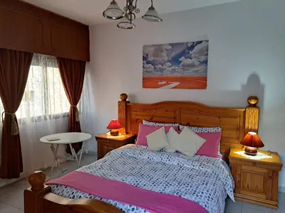 a bedroom with a bed with pink and white sheets at Shared Top 1st floor villa in Limassol