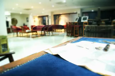 a view of a room with a table and chairs at M. Moniatis Hotel in Limassol