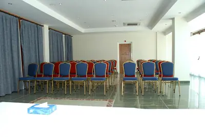 a room with a bunch of chairs in a room at M. Moniatis Hotel in Limassol