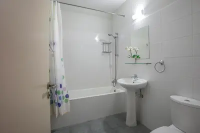 a bathroom with a sink and a tub and a toilet at Christabelle Hotel Apartments in Ayia Napa
