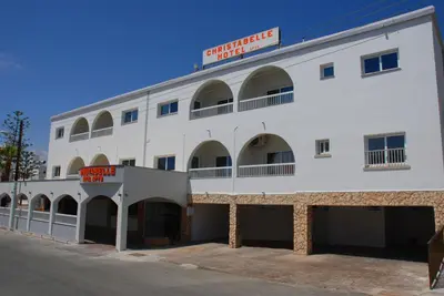 a large white building with a sign on it at Christabelle Hotel Apartments in Ayia Napa