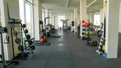 a gym with a lot of machines and weights at Amigos Apartment Mythical in Protaras