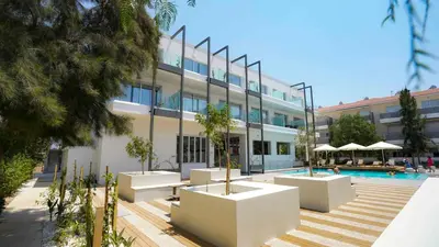 a large building with a swimming pool in front of it at Amigos Apartment Mythical in Protaras