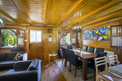a dining room with a table and chairs at Ricky Chalet Near Troodos in Spilia