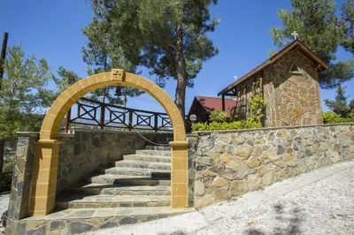 an archway over a stone wall with stairs at Ricky Chalet Near Troodos in Spilia