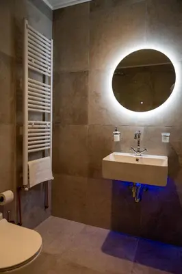 a bathroom with a sink and a mirror at New Helvetia Historic Hotel in Platres