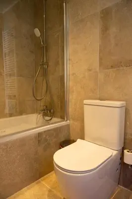a bathroom with a toilet and a shower at New Helvetia Historic Hotel in Platres