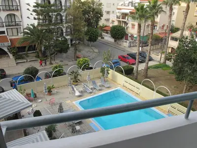 a view of a swimming pool from a balcony at San Remo Hotel in Larnaka