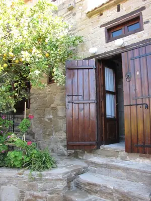 an entrance to a stone building with a wooden door at Vasilopoulos House in Tochni
