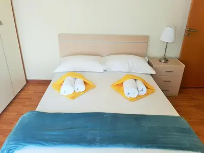 a bed with two towels and two pillows on it at 16 SANDY BEACH in Larnaka