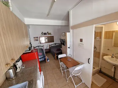 a small kitchen with a table and a sink at Nicosia rooms Studios in Nicosia