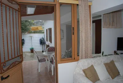 a room with a couch and a table and a balcony at Kanarinis House in Omodos