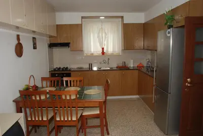 a kitchen with a table and chairs and a refrigerator at Kanarinis House in Omodos