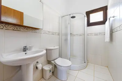a bathroom with a sink and a toilet and a shower at Villa Greco Mare #5 in Paralimni