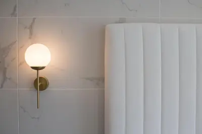 a lamp on a wall next to a book at Narcissos Waterpark Resort in Protaras